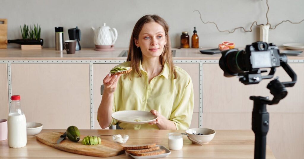 Woman filming avocado toast tutorial at home in modern kitchen for vlog.